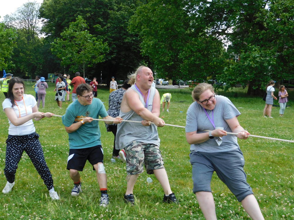 A group of people doing tug of war