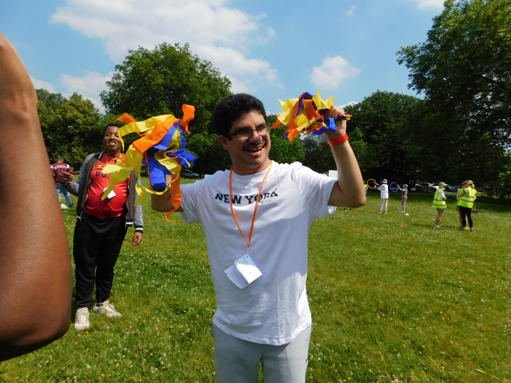 A man shaking cheerleading paper decorations