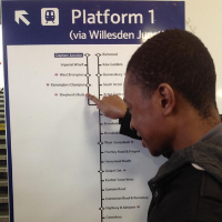 Close up of a man reading a train map on a large sign