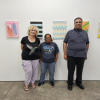 Former Share CEO Annie McDowall stands with two Share artists in front of their artwork