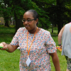 A lady carries an egg on a spoon in a sports day race