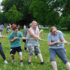 A group of people doing tug of war