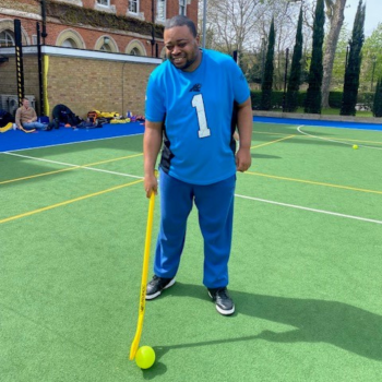 A man stands playing hockey