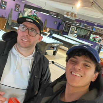 Two men take a selfie while they're out playing pool